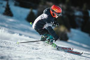 A young boy skiing down the mountain
